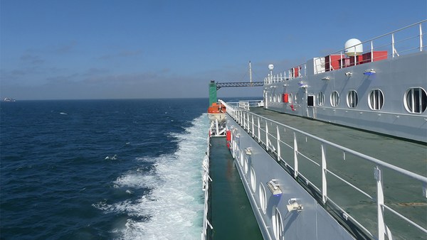 Outer deck of an Irish Ferries ship with the sea and wake beside it