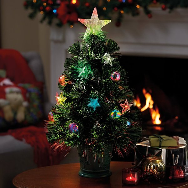 60cm potted fibre-optic Christmas tree glowing beside a fireplace
