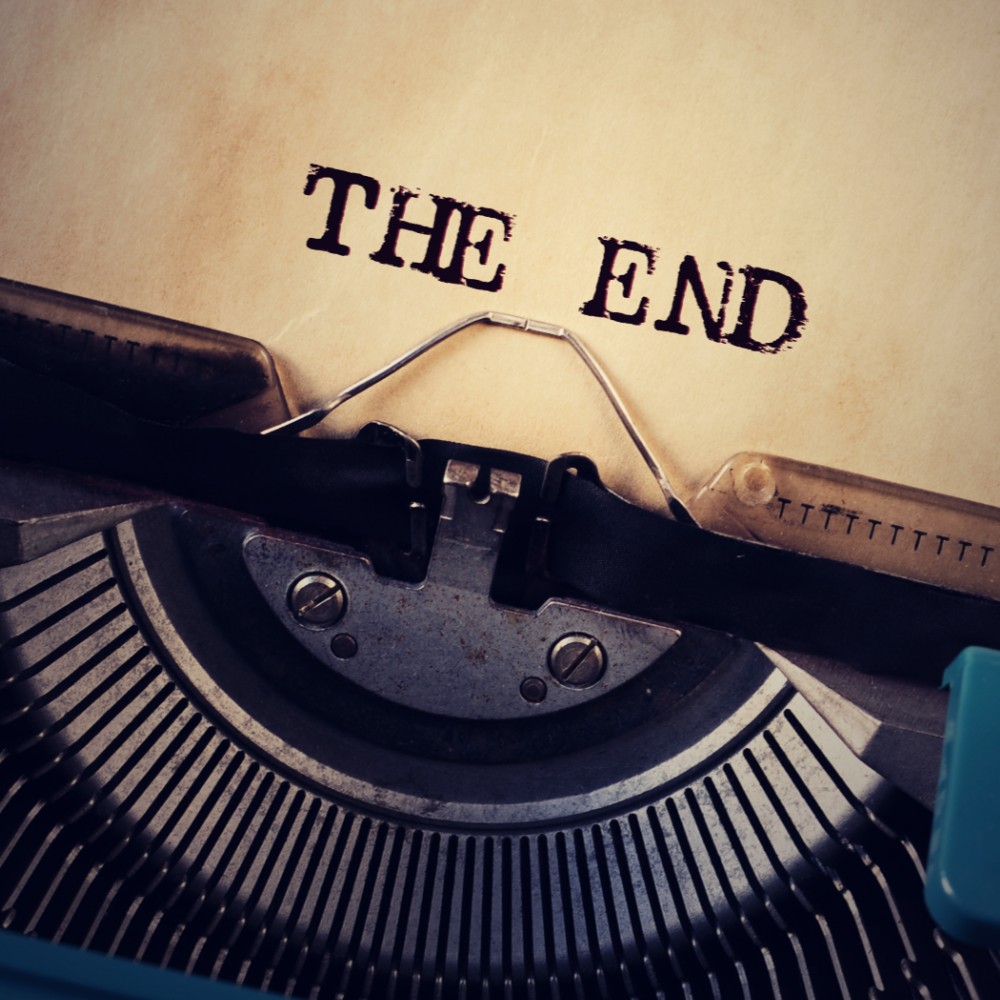 Typewriter with a sheet of paper reading The End
