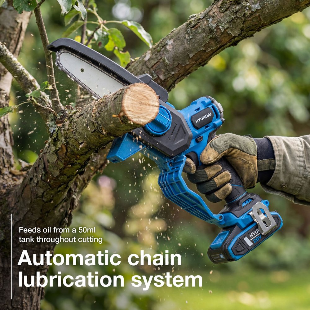 Hyundai 6 inch cordless mini chainsaw cutting a tree branch