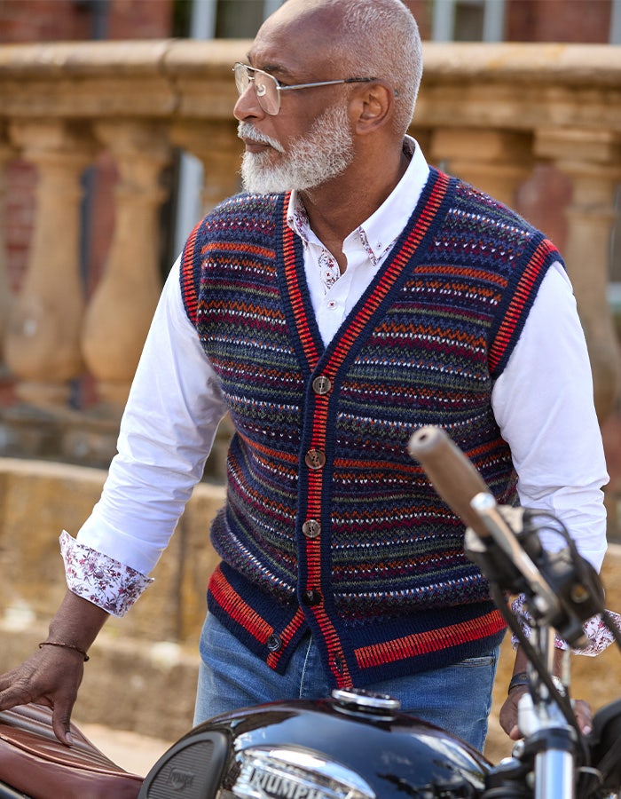Joe Browns patterned knitted waistcoat worn over a white shirt