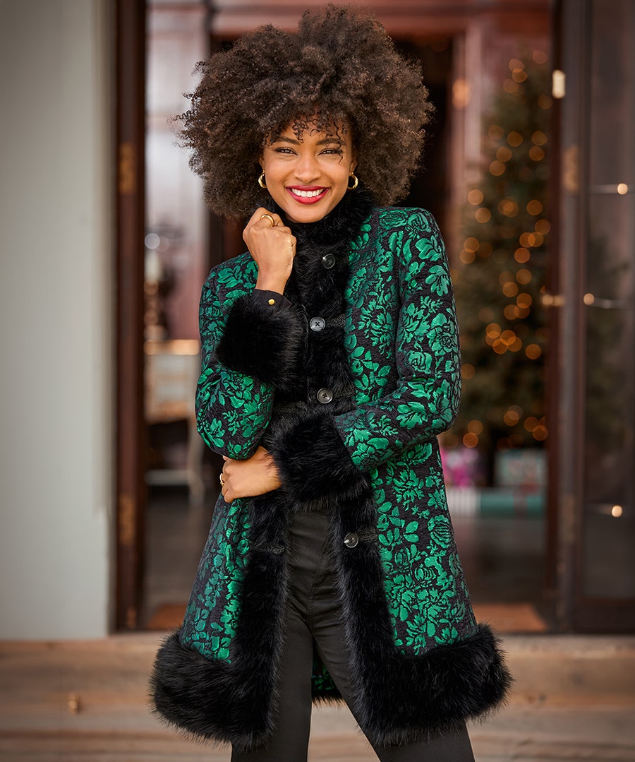 Woman wearing the Joe Browns Statement Jacquard Faux Fur Trim Coat in emerald and black