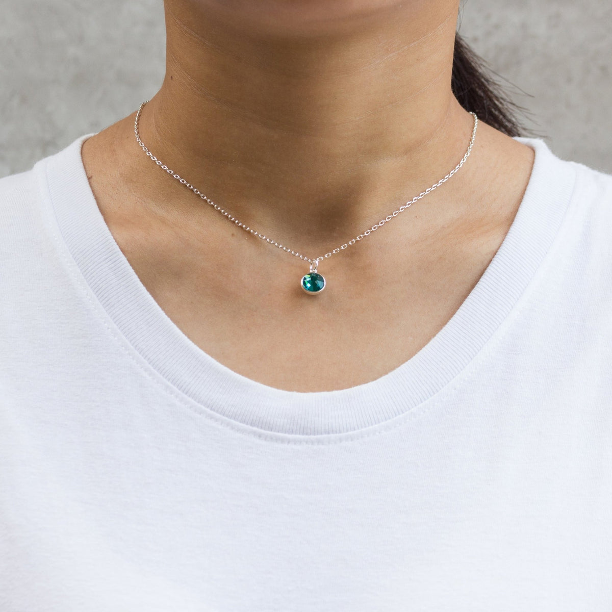 Philip Jones December blue topaz birthstone necklace worn on the neck