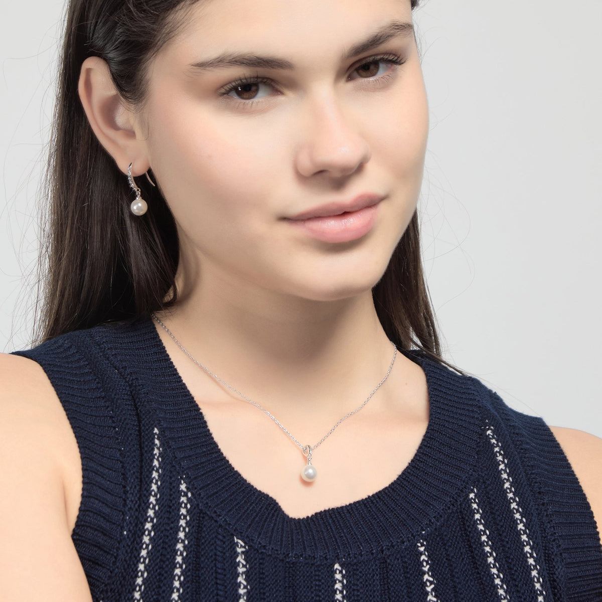 Model wearing Philip Jones silver plated pearl drop earrings and necklace