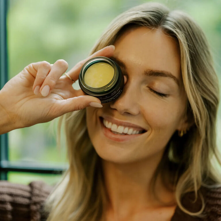 Primally Pure Skincare Bundles Explained: Foundation, Routine or Ritual for Your Skin Type Smiling woman holding a jar of Primally Pure Plumping Cream