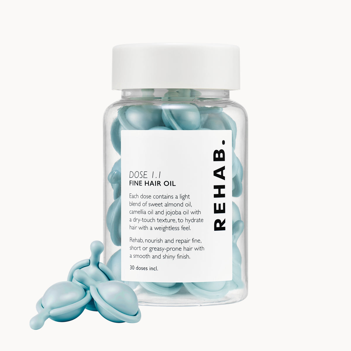 REHAB. Dose 1.1 Fine Hair Oil bottle with blue capsules