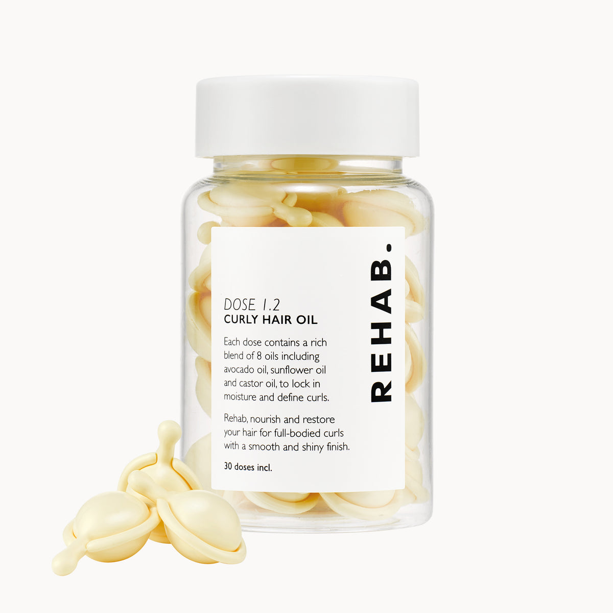 REHAB. Dose 1.2 Anti-Frizz Curly Hair Oil bottle with capsules