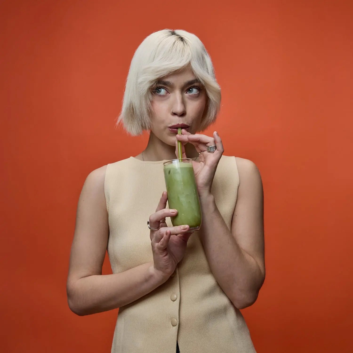 Woman drinking an iced Spacegoods Matcha Dust through a straw