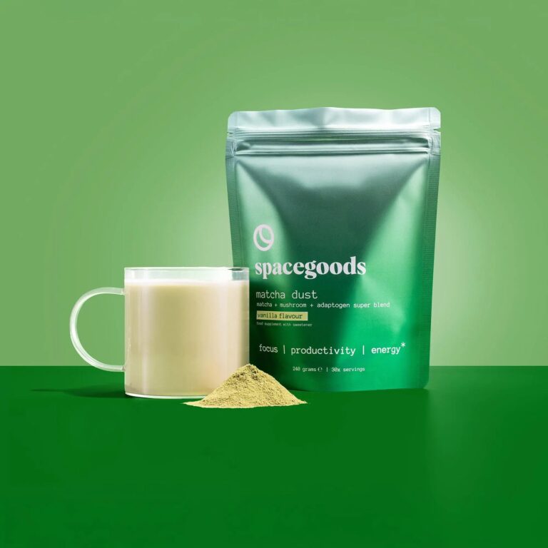 Spacegoods Matcha Dust vs Glow Dust: Which Daily Blend Suits You? Spacegoods Matcha Dust pouch next to a matcha latte on a green background