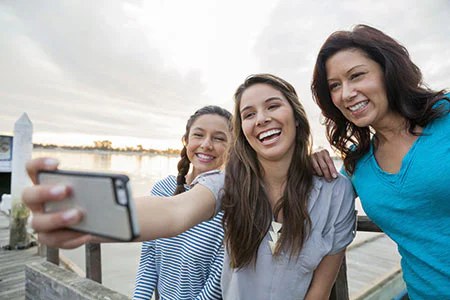 Using Lebara Abroad: Roaming in the EU, EEA and India Explained Three friends taking a selfie by the water on holiday