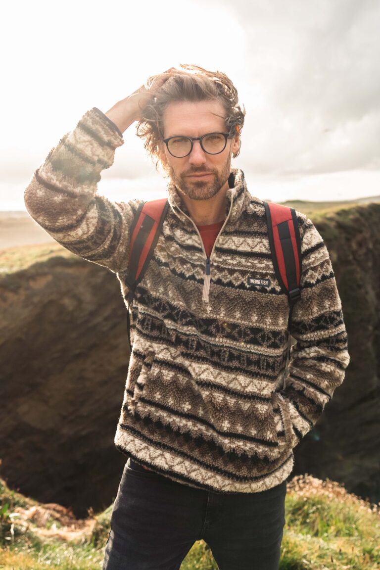 Weird Fish Men’s Fleeces Compared: Borg, Grid and Sherpa-Lined Styles for Winter Man wearing the Weird Fish Nash quarter zip jacquard borg fleece in Sandstone outdoors