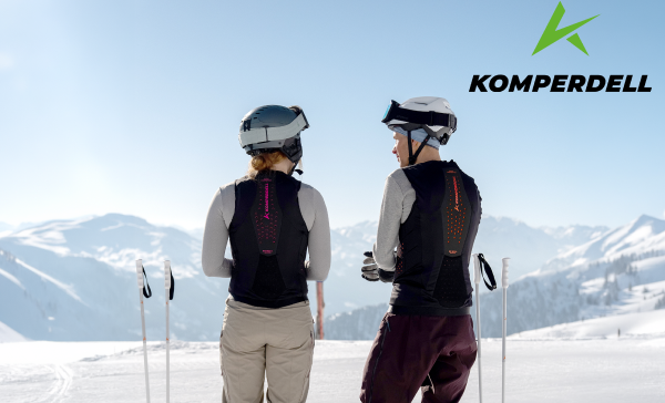 Two skiers wearing Komperdell back protectors in the mountains